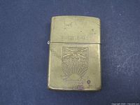 Front view showing crest, BOLD BRASS text, wear.