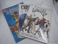 Three bagged comics overlapped showing titles and cover art