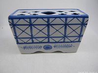 Front view of rectangular Delft blue and white porcelain flower frog vase showing lattice pattern