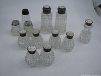 Group shot showing all twelve shakers in the lot