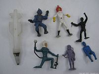 Group shot showing six spacemen and cap rocket