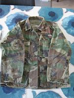 Front of woodland camouflage jacket showing overall style and button closure