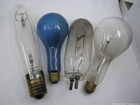 Group shot of four vintage light bulbs with varying shapes and bases