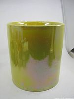 Front view of cylindrical yellow iridescent glazed flower pot
