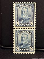 Front view of vertical pair of blue 8¢ Canada King George V Scroll stamps