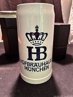 Front view showing HB crown logo and Hofbräuhaus München graphics on stoneware stein