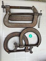 Four clamps laid out showing both styles