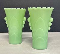 front view of both jadeite vases showing scalloped rims and side nodes