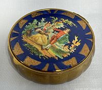 Closed compact showing enamel pastoral scene on lid