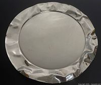 Front view of entire platter showing crumpled rim and flat center
