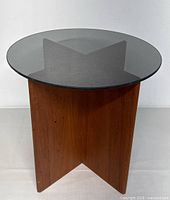 Front view showing round smoked glass top and wood X-base
