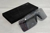 Sunglasses resting on closed original case