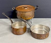 Full view of Baumalu copper lidded pot and two saucepans