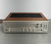 Front angled view showing full receiver, wood cabinet, controls