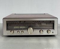 Front full view of Luxman R-1050 receiver showing knobs, meters, dial