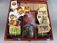 Interior view showing game components: hex tiles, cards, pieces in trays