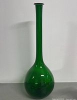 Full view of green Empoli glass bottle vase front