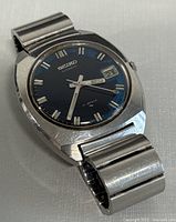Front angled view of Seiko wristwatch showing case, bracelet, dial and date window