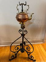 Full view of kettle on iron stand