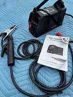 Welder unit, electrode holder, ground clamp, strap and manual