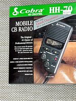 Front of retail box showing Cobra HH-70 mobile CB radio graphics and features