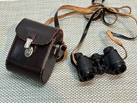Binoculars with leather case and neck strap