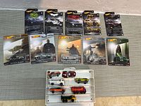 Top view showing 11 sealed Hot Wheels cards and carrying case with loose vehicles