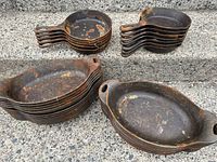 Stacks of round 3SK skillets and oval serving pans