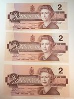 Three 1986 Canadian $2 bills front view