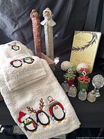 Group shot of towels, angel figurines, book, crystal items, card holders and box