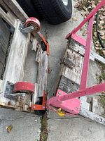 Overall view of trolley parts including pink handle and casters