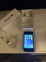iPhone 4S with cable, power adapter, open box and inserts
