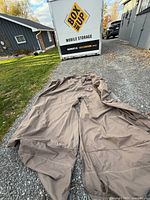 Full view of large taupe Ravenna cover laid out on driveway