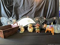 Full lot view showing iguana wall art, bowl, figurines, vase