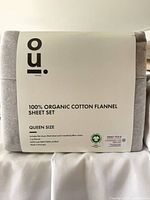 Front of packaged OUI sheet set showing branding and material