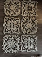 All six decorative panels laid out on floor