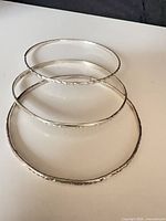Three sterling silver bangles stacked