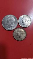 Group shot of 1972 Eisenhower dollar with 1974 and 1967 Kennedy halves