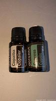 Front view of two 15 mL doTERRA essential oil bottles labeled Copaiba and Cypress