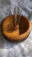 Top view of wood nut bowl with nutcracker and picks