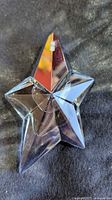Full view of star-shaped perfume bottle