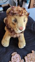 Front view of Steiff Leo Lion plush showing face and paws