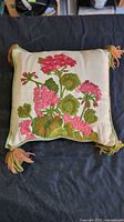 Full view of embroidered floral throw pillow