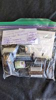 Zip bag containing nine essential oil bottles with handwritten note listing scents