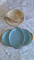 Lot overview showing beige gravy boat on tray and blue divided relish dish