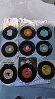 Grid view of nine 45 RPM singles with sleeves