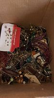 Top view inside box showing dense assortment of jewelry pieces