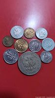 Group shot of all ten Polish coins arranged on red background