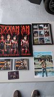 Entire lot layout showing posters, framed card set, CDs, photo, guitar picks