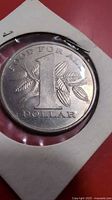 Reverse of 1969 Trinidad and Tobago 1 dollar coin in holder